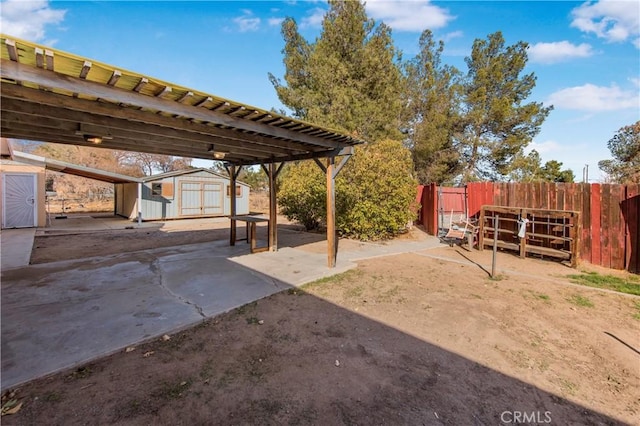 view of yard with a storage unit and a patio area