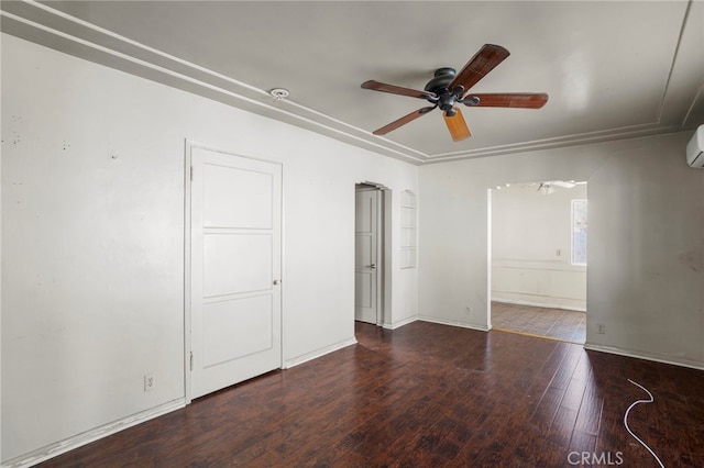 unfurnished room with ceiling fan, dark hardwood / wood-style flooring, and an AC wall unit