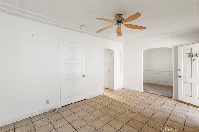 empty room with ceiling fan and ornamental molding