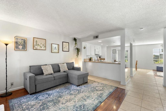 tiled living room with a textured ceiling