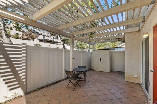 view of patio featuring a storage unit and a pergola