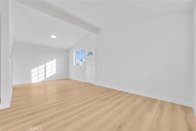 interior space featuring vaulted ceiling with beams and light hardwood / wood-style floors