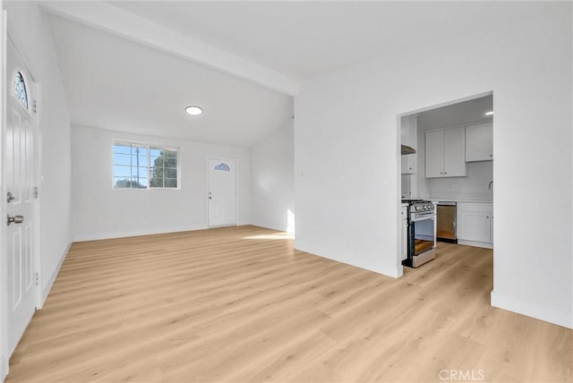 unfurnished living room featuring vaulted ceiling with beams and light hardwood / wood-style flooring