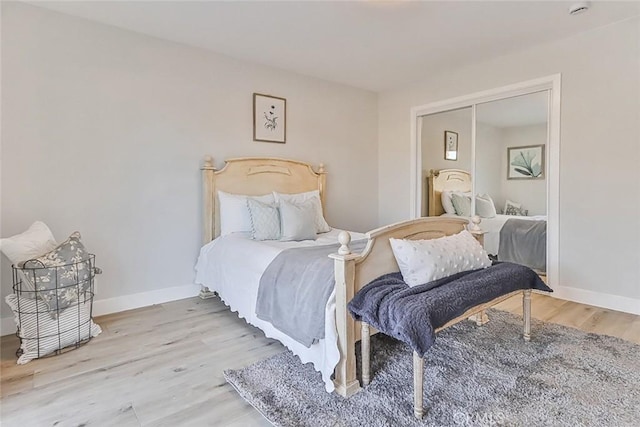 bedroom featuring light wood-type flooring and a closet