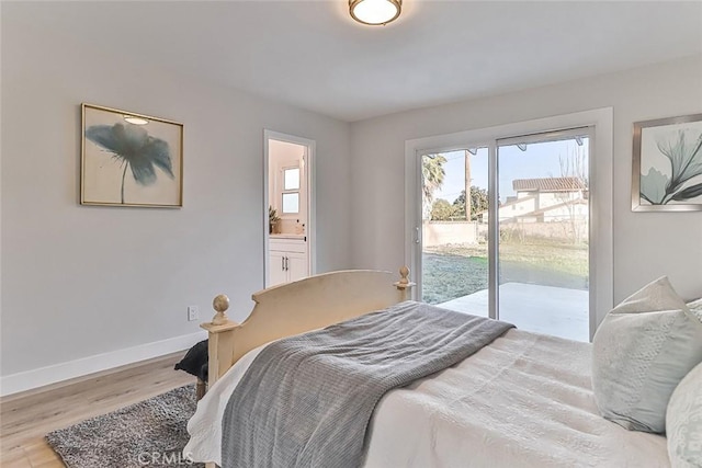 bedroom featuring connected bathroom, access to outside, and light hardwood / wood-style flooring