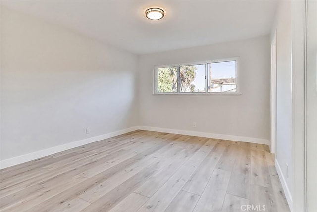 spare room featuring light wood-type flooring