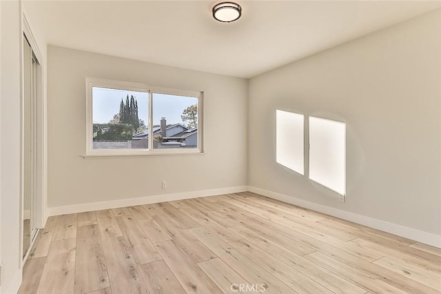 empty room with light hardwood / wood-style flooring