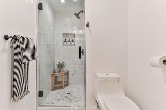 bathroom with an enclosed shower and toilet