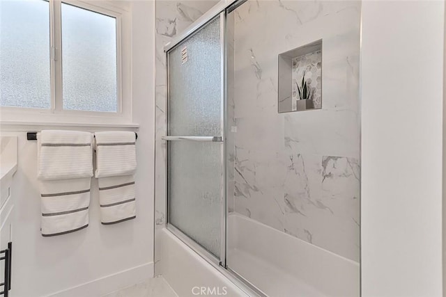 bathroom featuring shower / bath combination with glass door