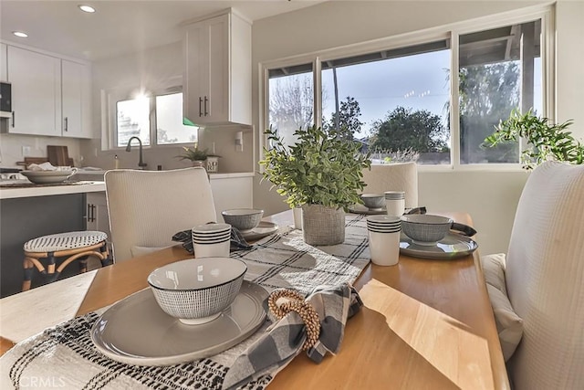 dining room featuring hardwood / wood-style floors and sink