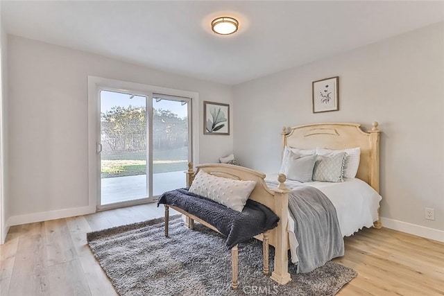 bedroom with access to exterior and light wood-type flooring