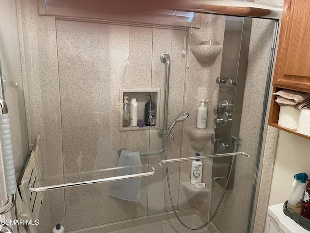 bathroom with a shower with door