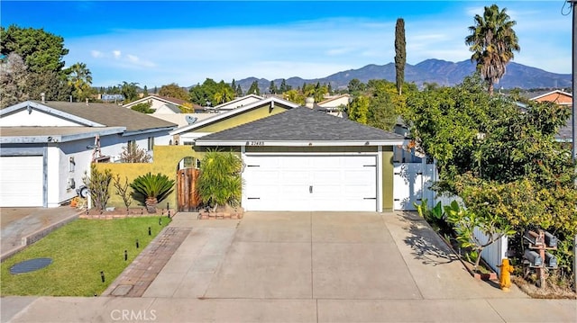 ranch-style house with a mountain view and a garage