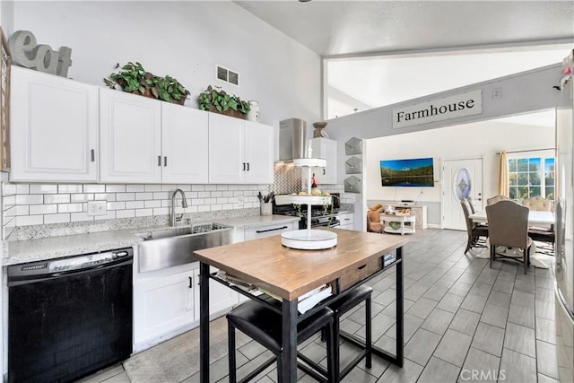 kitchen with white cabinets, black dishwasher, sink, backsplash, and stainless steel range with electric stovetop