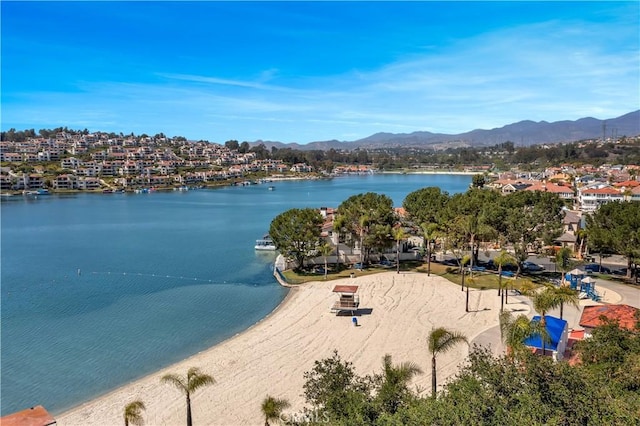 drone / aerial view featuring a water and mountain view