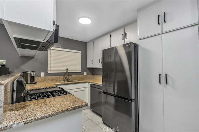 kitchen with stainless steel fridge, dishwasher, light stone countertops, white cabinets, and sink