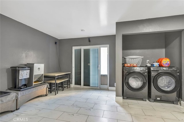 clothes washing area with separate washer and dryer