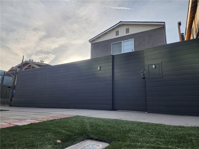 view of side of home with a lawn