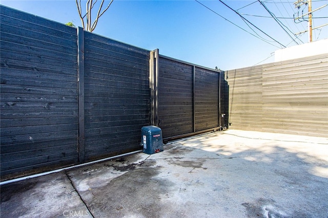 view of gate featuring a patio