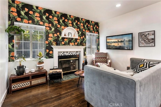 living room with dark hardwood / wood-style floors and a tile fireplace