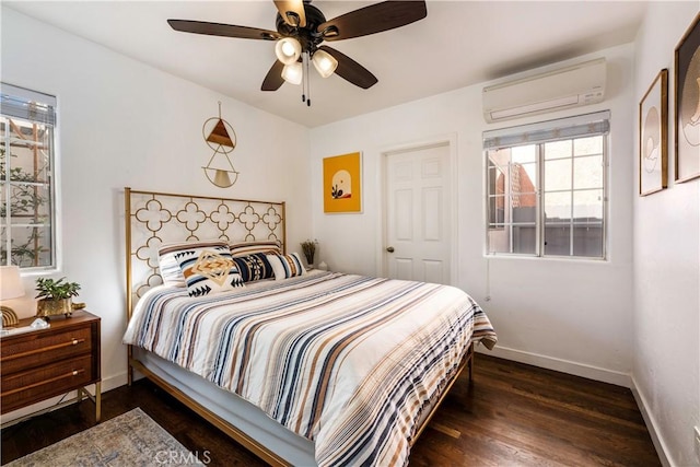 bedroom featuring ceiling fan, an AC wall unit, and dark hardwood / wood-style floors