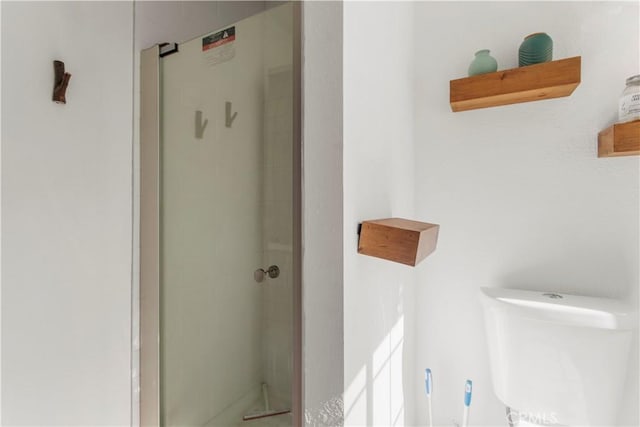 bathroom with toilet and walk in shower