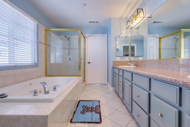 bathroom with a stall shower, tile patterned flooring, visible vents, and vanity