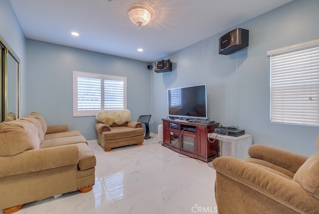 living area featuring recessed lighting and marble finish floor