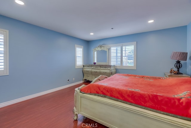 bedroom featuring recessed lighting, wood finished floors, and baseboards