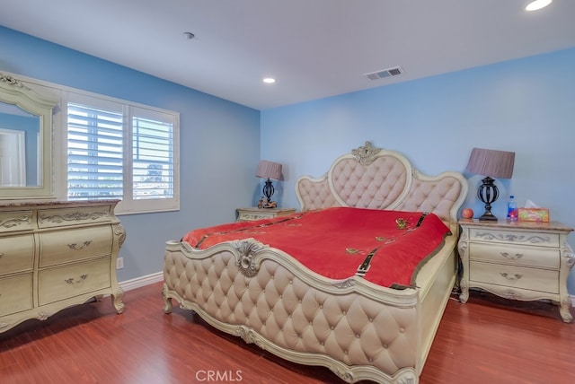 bedroom featuring recessed lighting, visible vents, baseboards, and wood finished floors