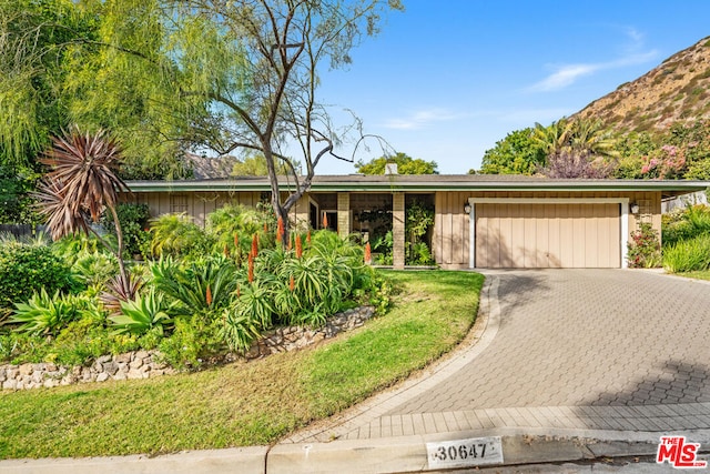 single story home featuring a garage and a mountain view