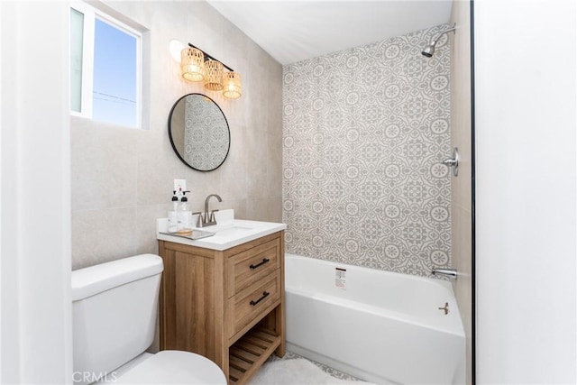 full bathroom with vanity, toilet, shower / washtub combination, and tile walls