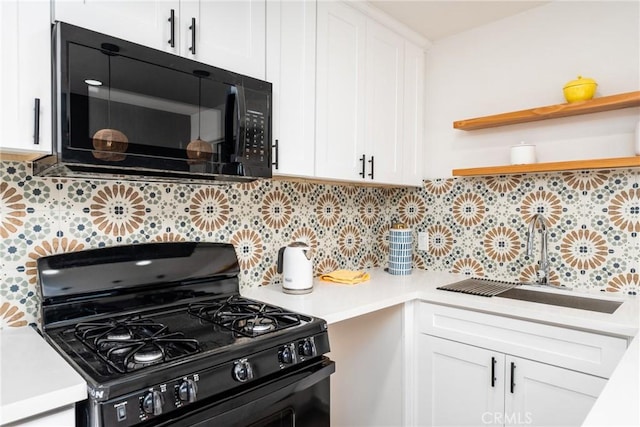 kitchen featuring tasteful backsplash, sink, white cabinetry, and black appliances