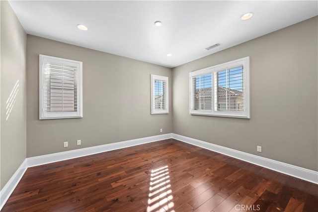 unfurnished room with dark hardwood / wood-style floors