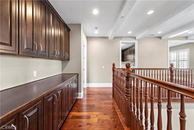 hallway with dark hardwood / wood-style floors and beamed ceiling