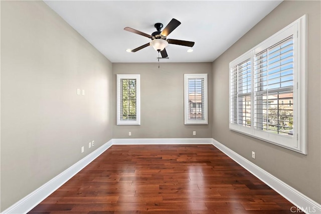 spare room featuring dark wood-type flooring and ceiling fan