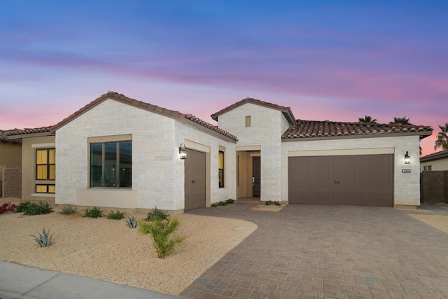 mediterranean / spanish-style home with a garage