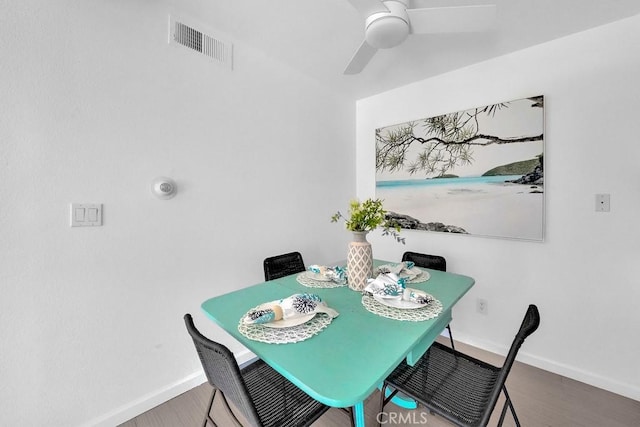 dining space with ceiling fan and hardwood / wood-style floors