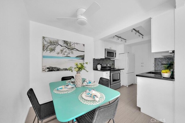 dining room featuring ceiling fan and track lighting