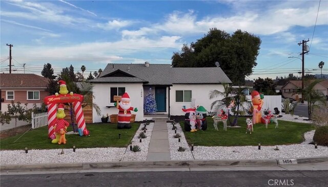 bungalow-style home featuring a front lawn