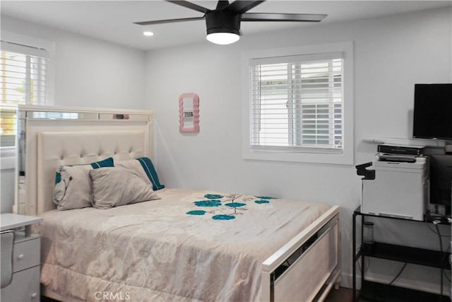 bedroom with ceiling fan and multiple windows