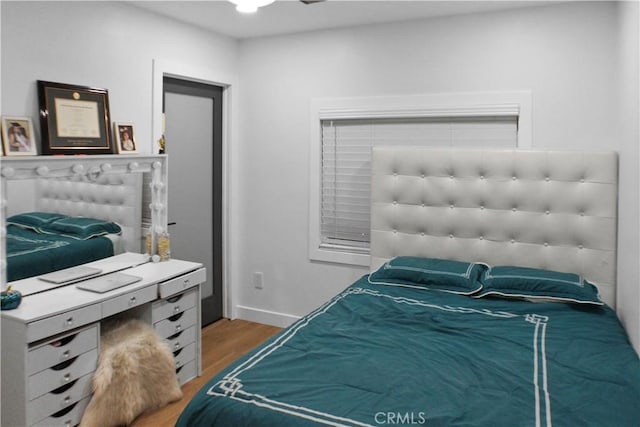 bedroom with hardwood / wood-style flooring