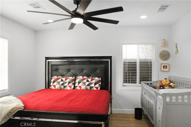 bedroom with ceiling fan and hardwood / wood-style flooring