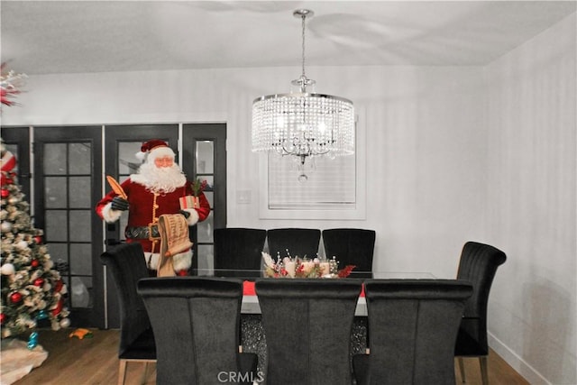 dining room featuring an inviting chandelier and wood-type flooring