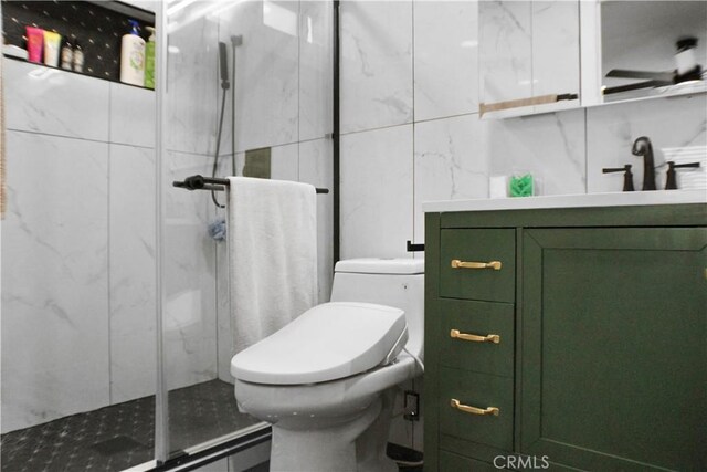 bathroom with toilet, tile walls, a shower with shower door, and vanity