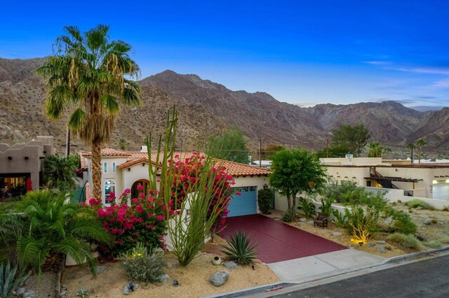 view of front facade featuring a mountain view and a garage