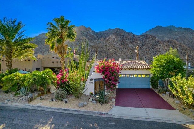 view of front of home featuring a mountain view and a garage