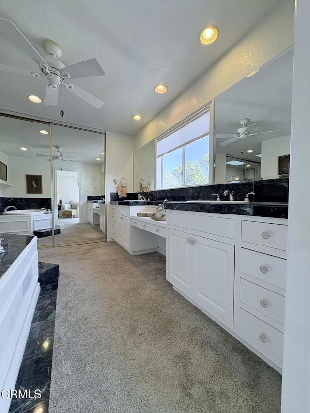 kitchen featuring white cabinetry and light colored carpet