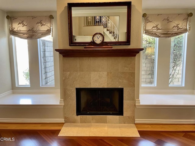 room details featuring hardwood / wood-style flooring and a tiled fireplace