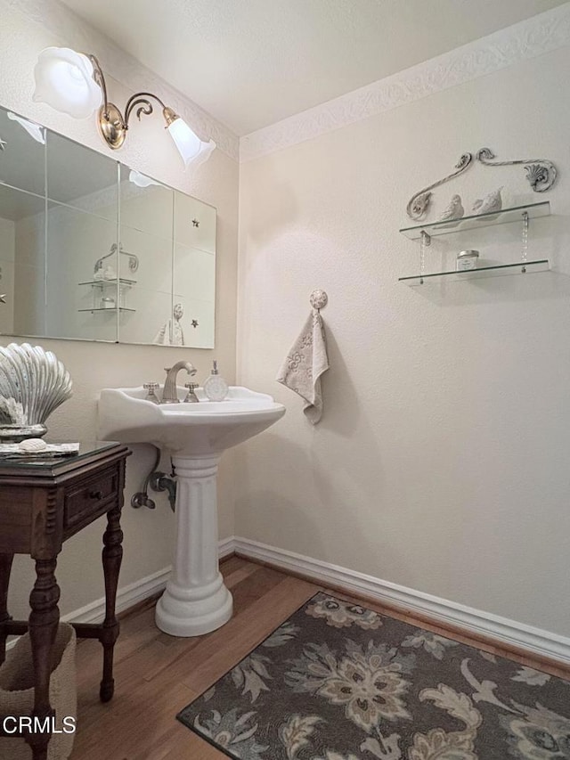 bathroom with hardwood / wood-style flooring